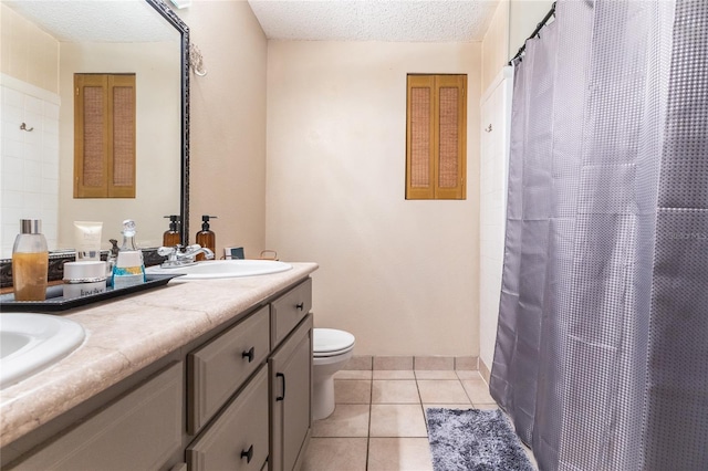 bathroom with toilet, tile patterned floors, a textured ceiling, vanity, and walk in shower