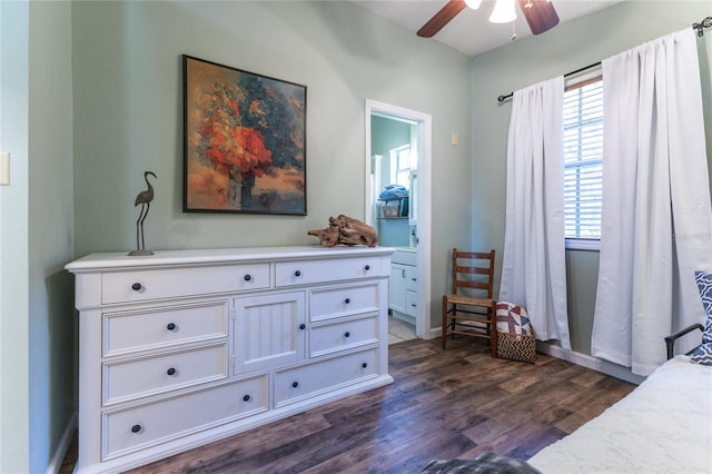 bedroom with a textured ceiling, dark wood-type flooring, and ceiling fan