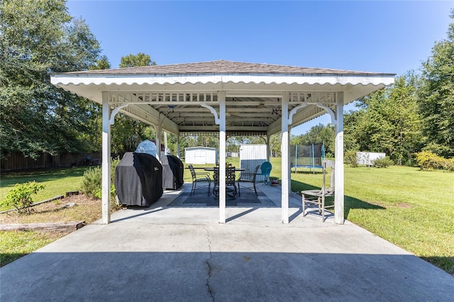 view of patio with grilling area, a gazebo, and a trampoline