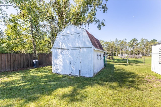 view of outbuilding with a yard