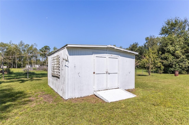 view of outbuilding featuring a lawn