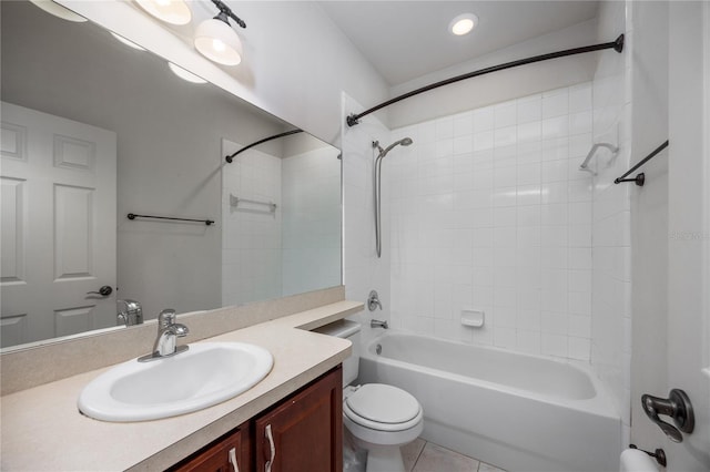 full bathroom featuring tile patterned floors, vanity, toilet, and tiled shower / bath