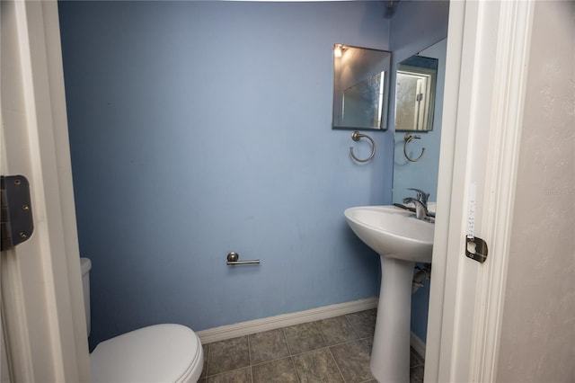 bathroom featuring tile patterned flooring and toilet