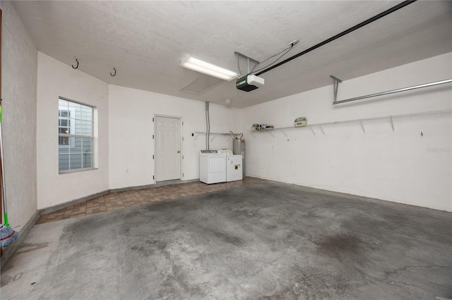 garage with washing machine and dryer and a garage door opener