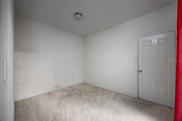 unfurnished room with light carpet