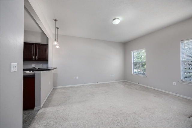 unfurnished living room with light colored carpet