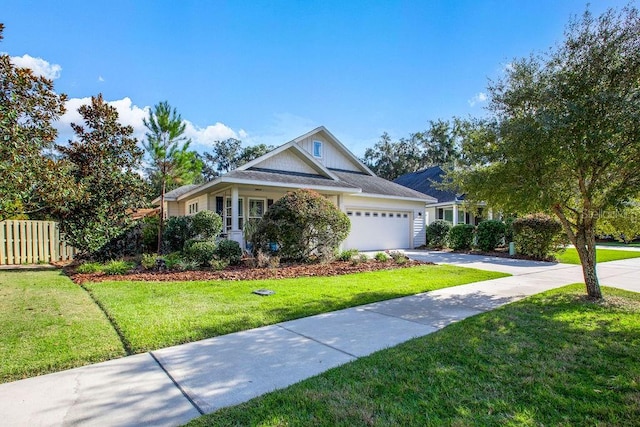 view of front of house featuring a front lawn and a garage