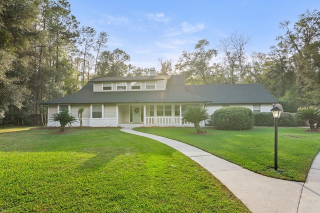 view of front of house with a porch and a front lawn