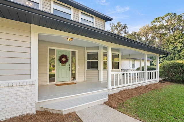 view of exterior entry featuring a porch