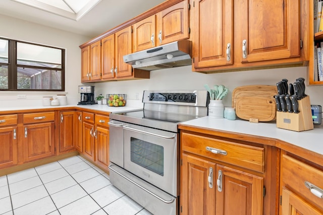 kitchen featuring light tile patterned floors and electric range