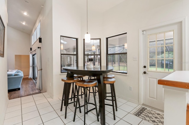 dining space featuring light hardwood / wood-style flooring and high vaulted ceiling