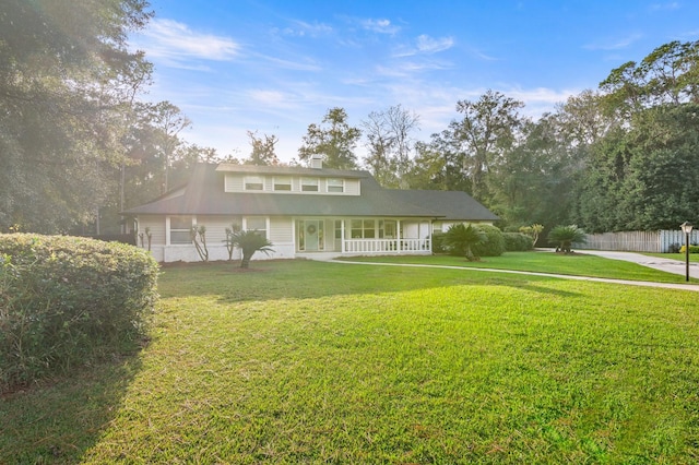 view of front of property with covered porch and a front lawn