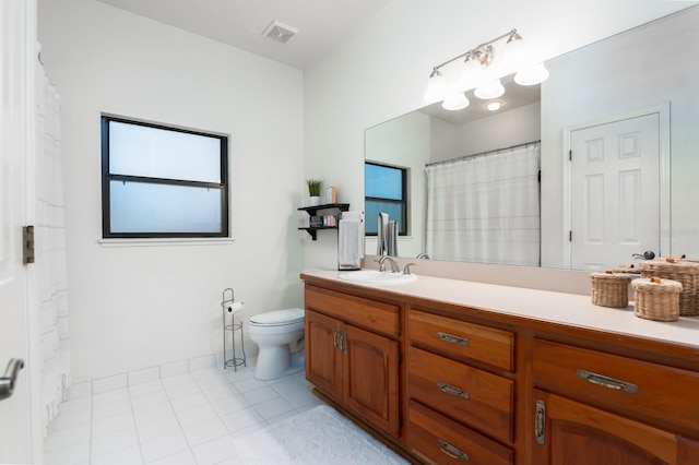 bathroom featuring toilet, vanity, and tile patterned floors