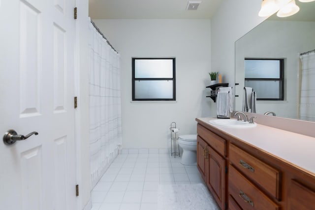 bathroom with tile patterned flooring, vanity, and toilet