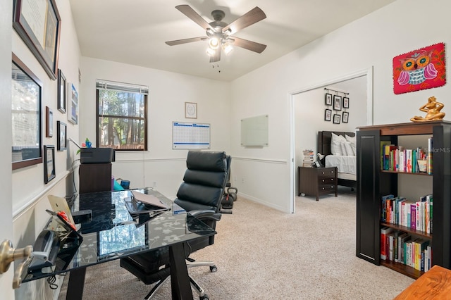 home office with ceiling fan and light colored carpet