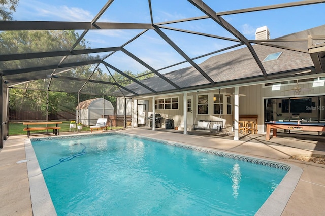 view of pool featuring ceiling fan, a patio, and glass enclosure