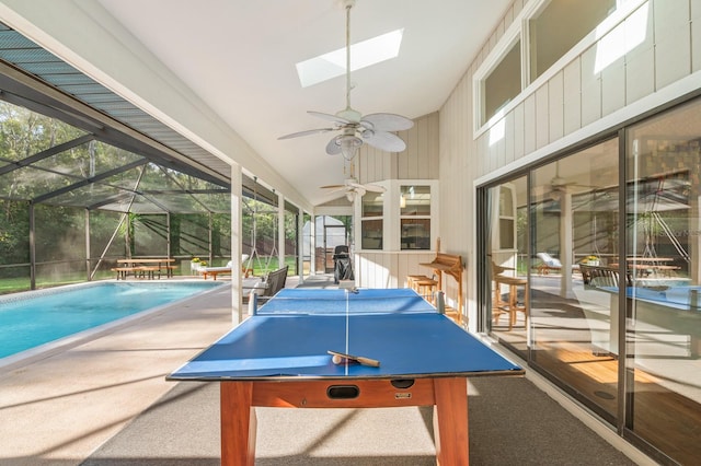 game room featuring carpet floors, plenty of natural light, and vaulted ceiling with skylight