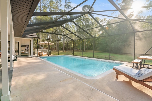 view of swimming pool with a patio area, a lanai, and a lawn