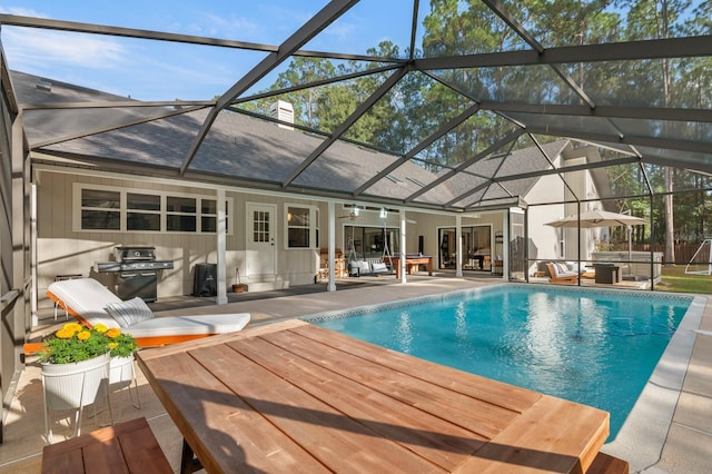 view of pool featuring ceiling fan, a patio area, and glass enclosure