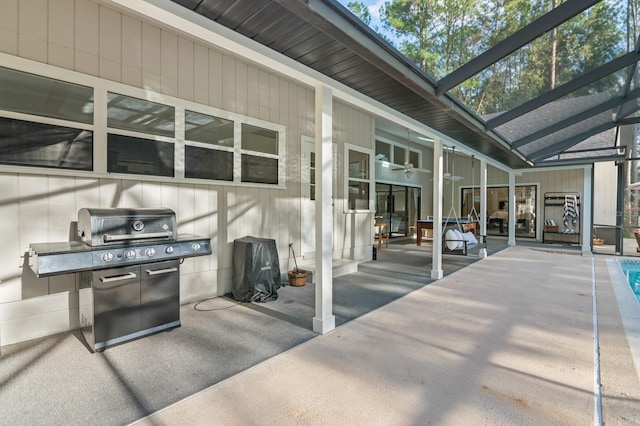 view of patio featuring a lanai, a grill, ceiling fan, and a pool