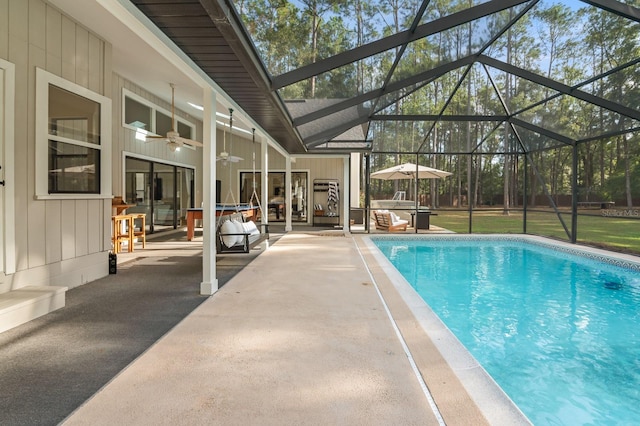 view of swimming pool with a lanai, ceiling fan, and a patio