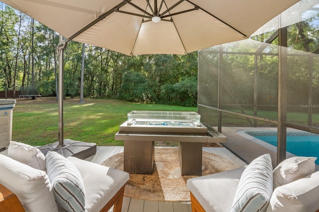 view of patio with an outdoor living space with a fire pit