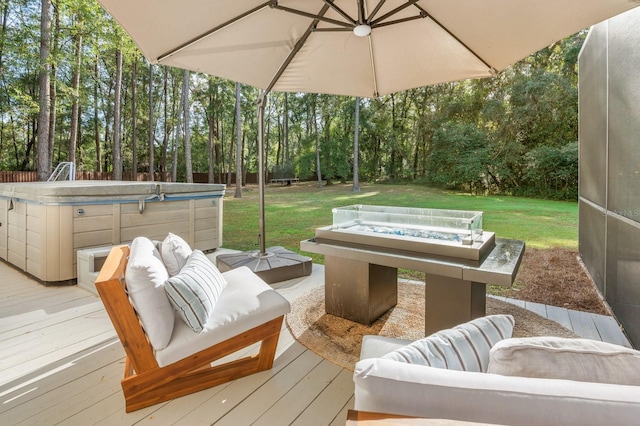 deck with a lawn, an outdoor living space with a fire pit, and a hot tub