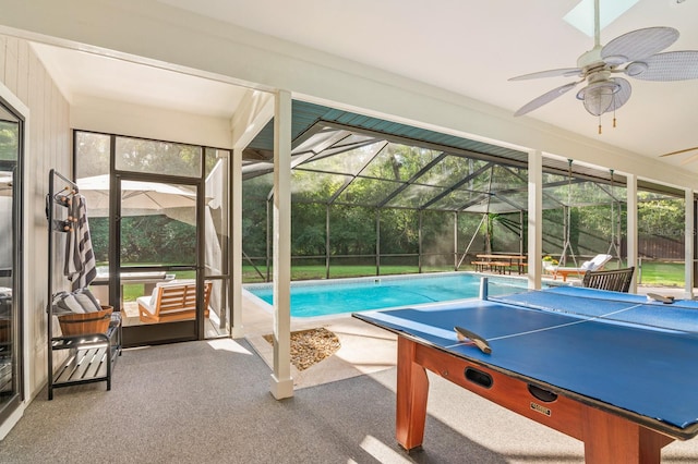 exterior space with glass enclosure, ceiling fan, and a patio