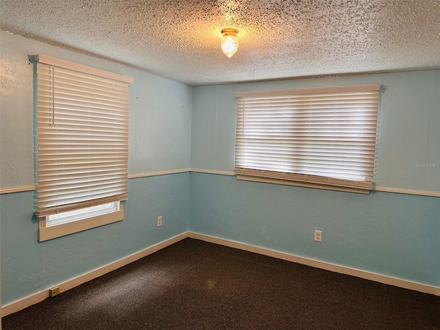 unfurnished room featuring a textured ceiling