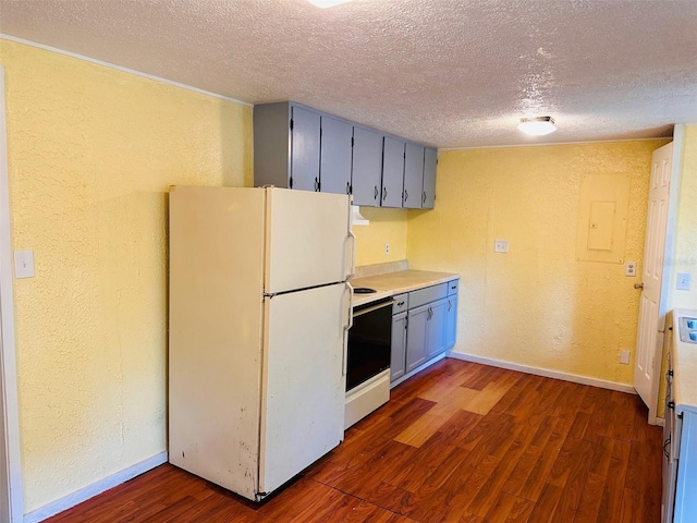 kitchen featuring dark hardwood / wood-style flooring, a textured ceiling, and white appliances