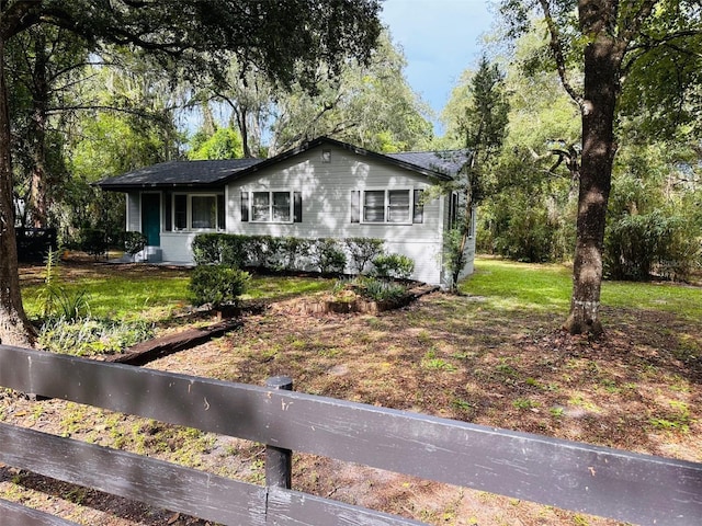 ranch-style home with a front lawn