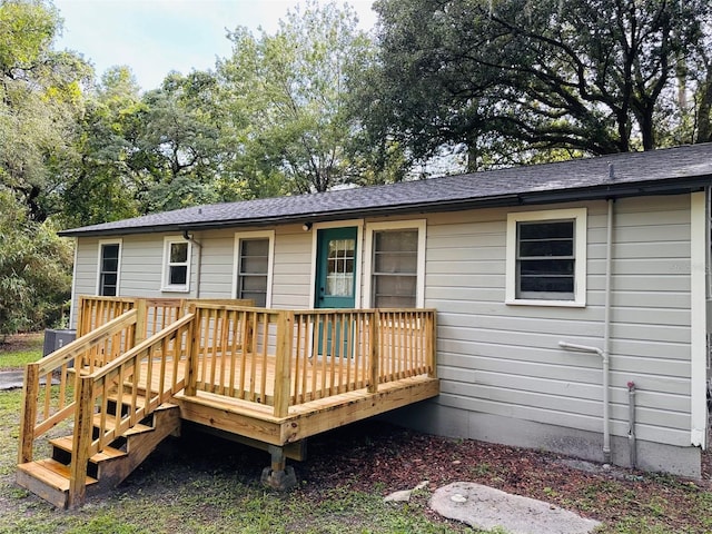 back of property with a wooden deck