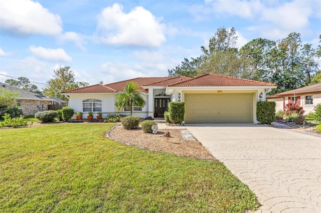 mediterranean / spanish home with a front yard and a garage