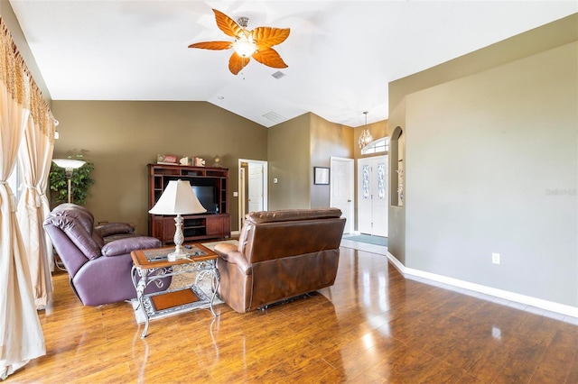 living room featuring ceiling fan with notable chandelier, wood-type flooring, and lofted ceiling