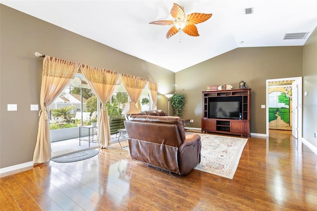 living room featuring ceiling fan, hardwood / wood-style floors, and lofted ceiling