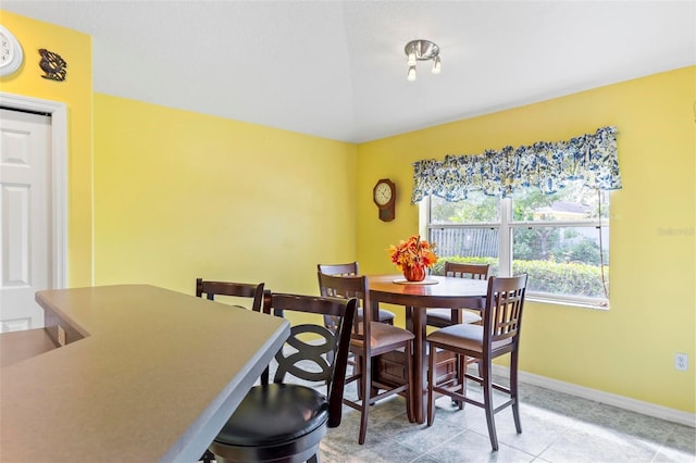 dining space featuring light tile patterned floors