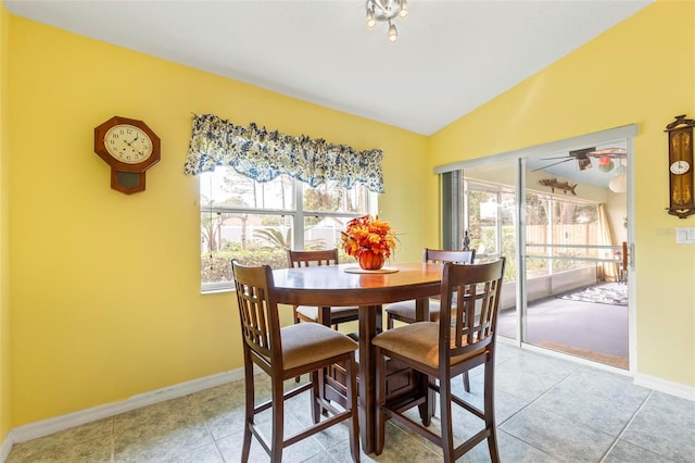 dining space featuring lofted ceiling and light tile patterned flooring