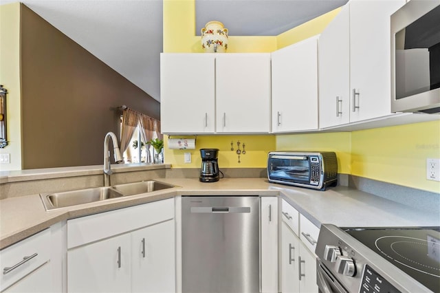 kitchen featuring sink, appliances with stainless steel finishes, and white cabinetry