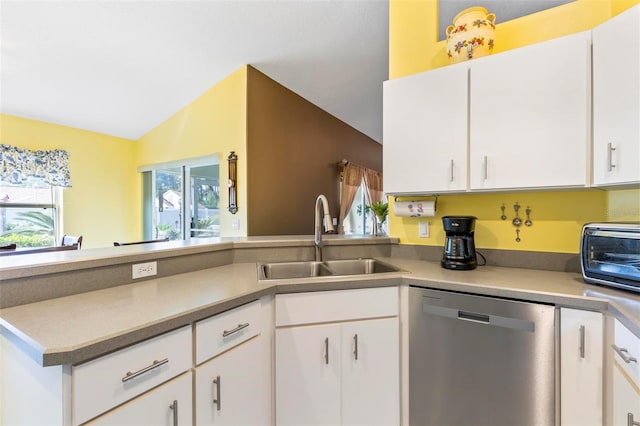 kitchen featuring sink, white cabinets, dishwasher, and vaulted ceiling