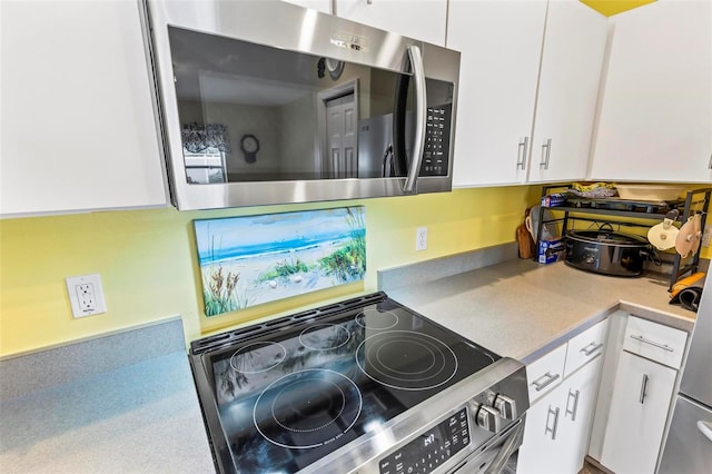 kitchen with stainless steel appliances and white cabinetry