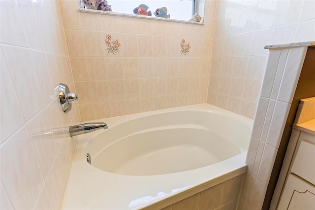 bathroom with vanity and a tub