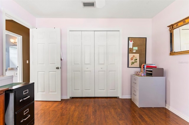 bedroom featuring dark hardwood / wood-style flooring and a closet