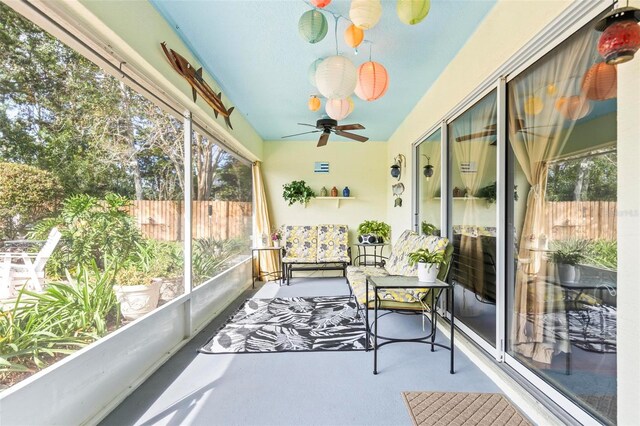 sunroom / solarium featuring ceiling fan