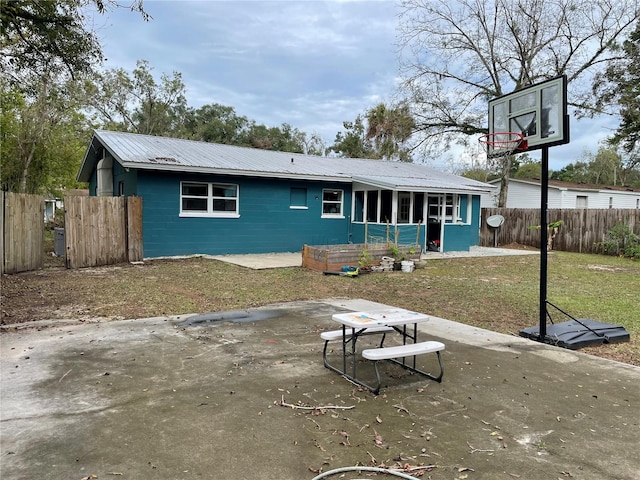 rear view of property with a yard and a patio area