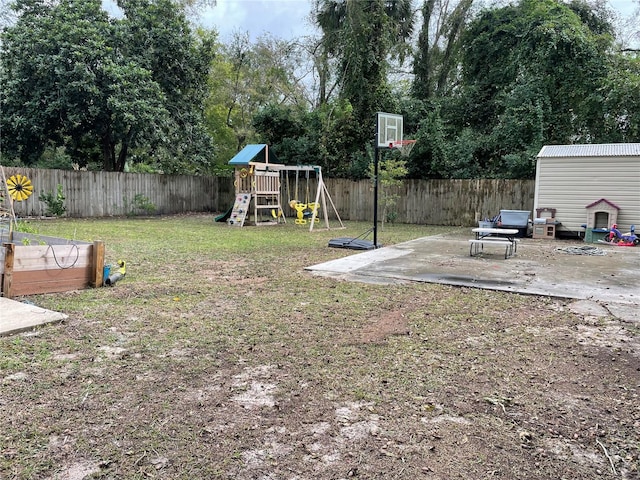 view of yard featuring a playground and a patio