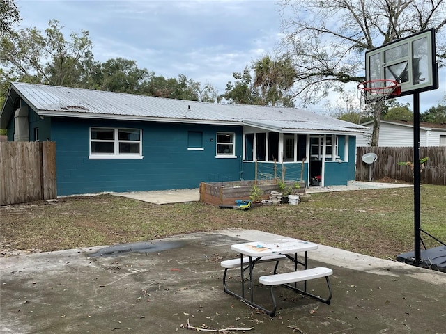 rear view of house featuring a yard and a patio