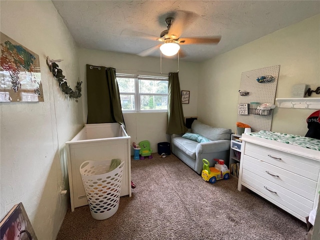 bedroom featuring a textured ceiling, carpet floors, and ceiling fan