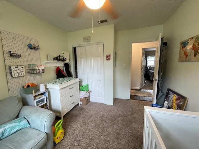 carpeted bedroom with a closet and ceiling fan