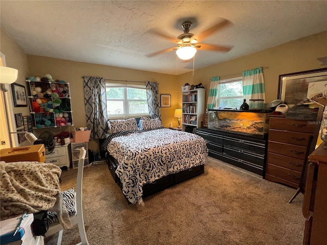 bedroom featuring multiple windows, carpet, and ceiling fan