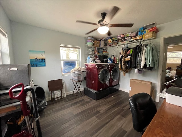 bedroom featuring washing machine and clothes dryer, multiple windows, and dark hardwood / wood-style flooring